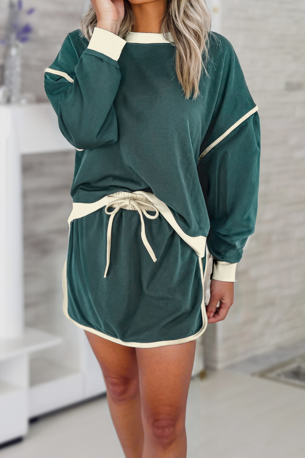evergreen color contrast loose pullover and lace-up waist skort set